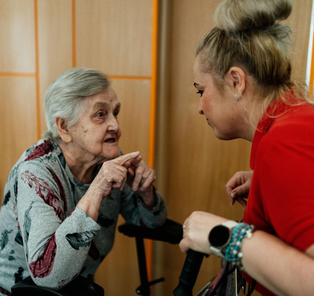 Compassionate caregiver supporting an older adult at home